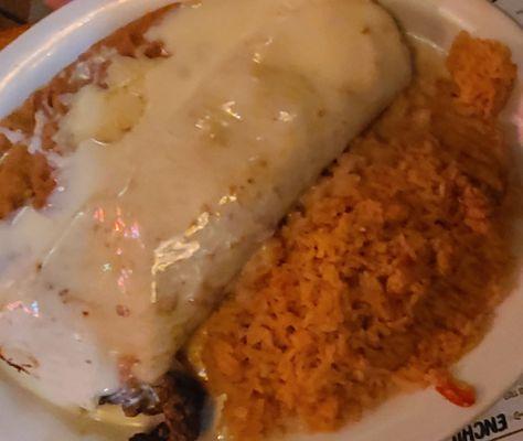 Steak California burrito with side of refried beans and mexican rice