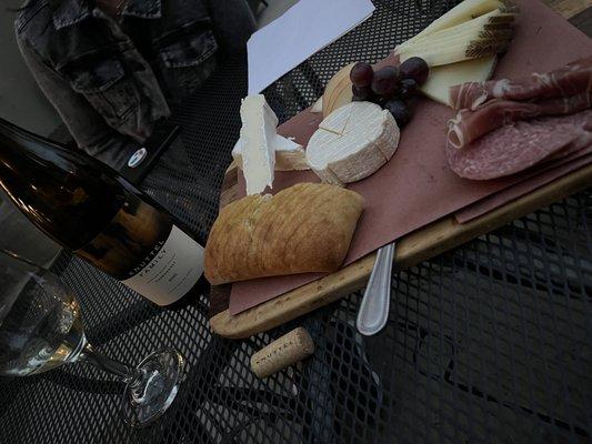 Cheese board and bottle of Chardonnay