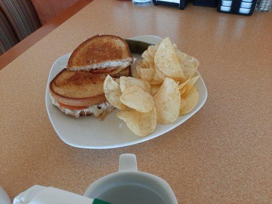 Tuna melt - our tuna salad perfectly grilled on Rye bread, swiss cheese, and tomato.