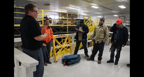 Students in confined space (industrial) rescue with STS instructor, Alex, learning about entrance/exit from space.