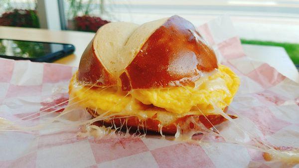 Egg and swiss cheese on a pretzel baguette