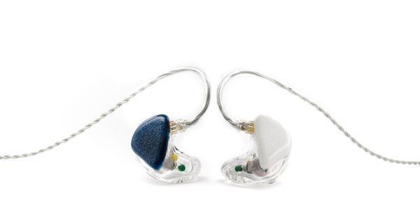 Custom in-ear monitors with clear shells and blue and white pearlescent face plates.