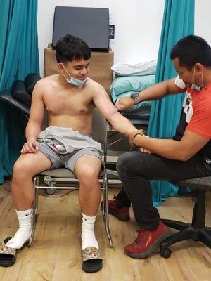 Jimwell pacquiao son of manny pacquiao getting Graston technique treatment by our sports rehab director Brian