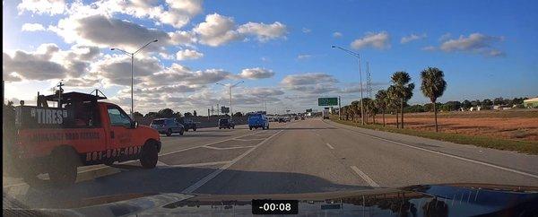 Company vehicle crossing and cutting off merging traffic