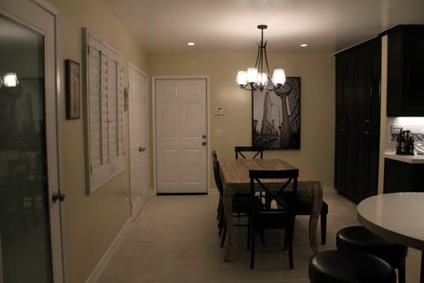 Dining room with wood like rectangular tiles.