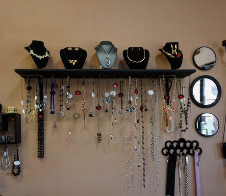 Hanging necklace display, multiple styles including necklace/earring sets.