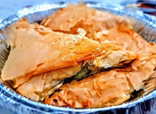 Spanakopites: spinach and feta cheese wrapped in flaky phyllo dough.