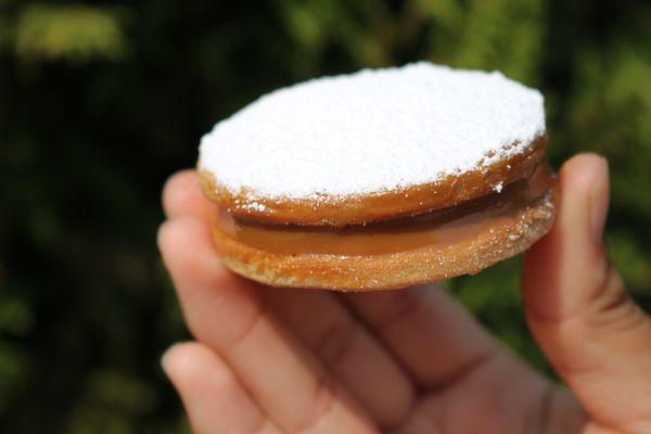 The Best Peruvian Alfajores!  SHortbread cookie filled with dulce de leche and topped with powder sugar