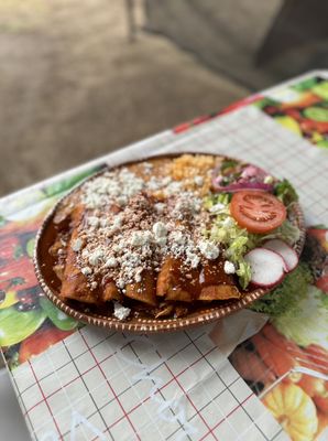 This is our Enchiladas Rojas with Arroz y Frijoles