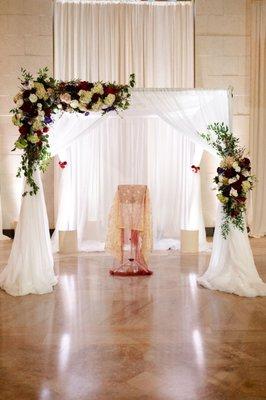 Wedding ceremony set up, including drapery and Chuppah from TeamImpulse.