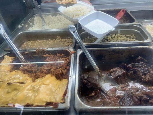 Pasta especial front left with pinto beans and rice behind. Pork neck, green beans, and turkey necks on right.