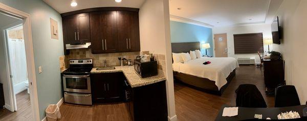 Panoramic view of kitchen and bedroom.