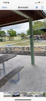 Tables outside of the single shelter as bathrooms were in the building in the distance.