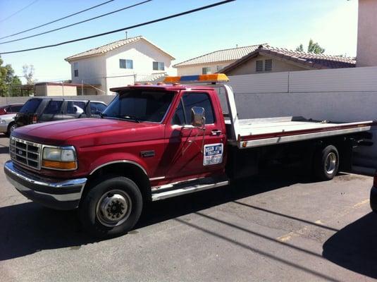 Need a tow? Nellis Auto Collision Center flatbed tow truck.