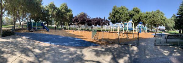 Pano view. Left playground is kids. Right is bigger kids. Note the green fence in the middle that separates the two.