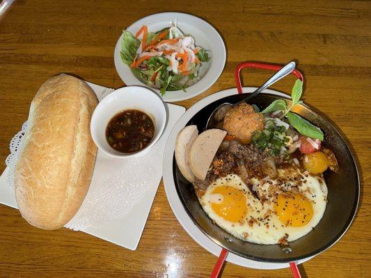 Banh Mi Chao, French bread eat with filet mignon, meat ball, pate, port patty, sunshine up eggs, and salad.