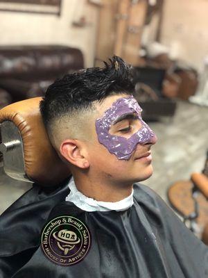 Mid fade haircut with face waxing.