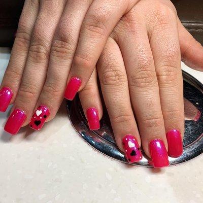 Red nails with purple color undertones and hand drawn hearts