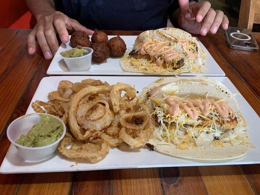 Mahi and grouper tacos with hush puppies and onion straws.