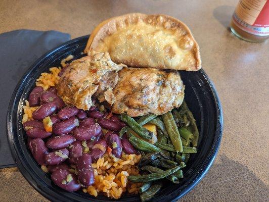 Jerk chicken with yellow rice and beans, green beans, and beef empanada