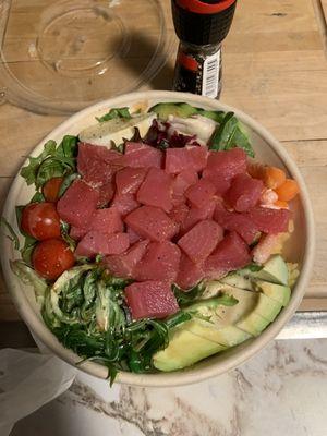 Salmon poke bowl with white sauce and teriyaki sauce.