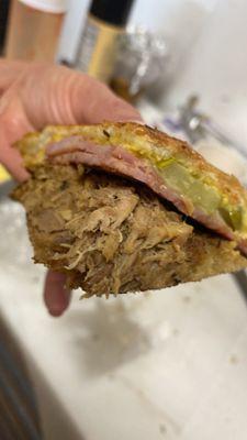 The Cubano is made with our home made slow roasted pork, sweet ham topped with Swiss cheese, pickles and mayo/mustard.