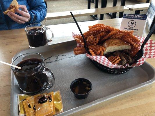 Awesome BBQ Brisket Sandwich with massive sticky sweet potato fries.