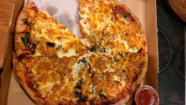 Piece chowed down spinach, chicken, feta "party pizza" Leoni's Bonita Springs Sunday 1-24-24