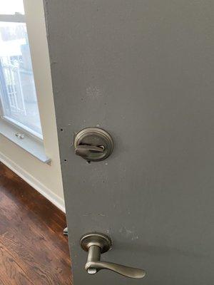 Poorly painted door and new loose locks.