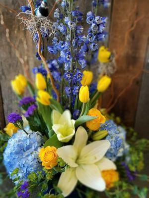 Spring yellow blue white funeral sympathy flowers.