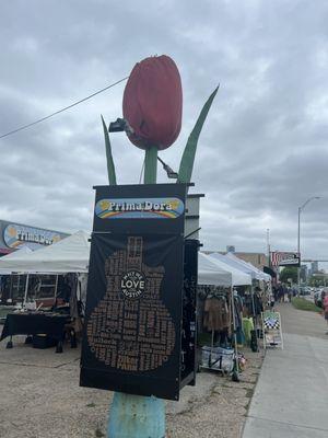 Signage in front of store and pop up vendor tents