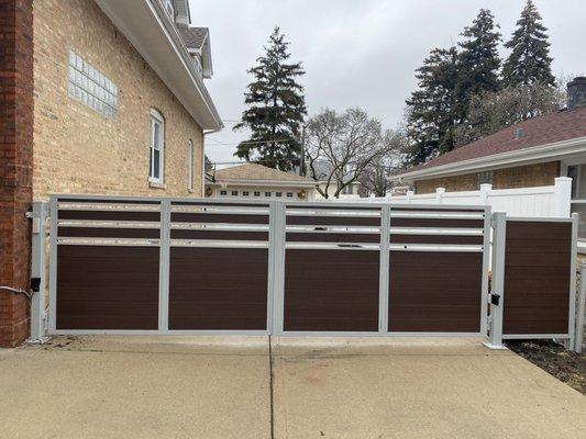 Custom built automated swing gate system with partial fence , made with European green wood