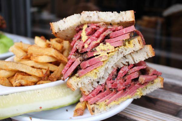 Our Smoked Meat Sandwich: Cured & smoked beef brisket, served with mustard, on rye