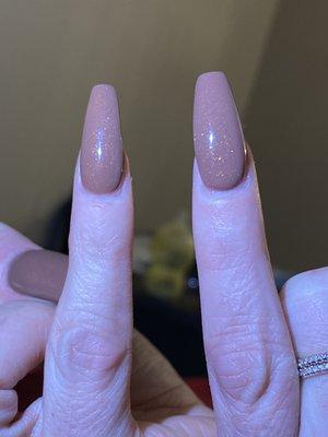 On the right is the "fixed" pinky nail that is clearly bigger and shaped way different then the right