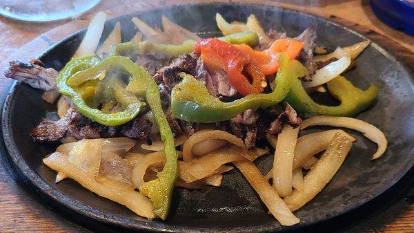 Hot, steaming steak fajitas