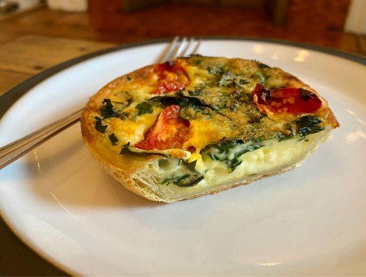 Quiche featuring charred broccoli, bursting cherry tomatoes and harmonious proportions of custard and pastry.