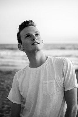 Male portrait on the beach, black and white. Headshot, model photography. Shot by Emma Bertrand.