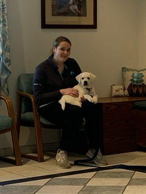 Our tech Caitlyn sitting with a new puppy and making him comfortable.