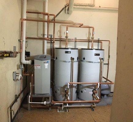 New water heater and storage tanks serving four condos