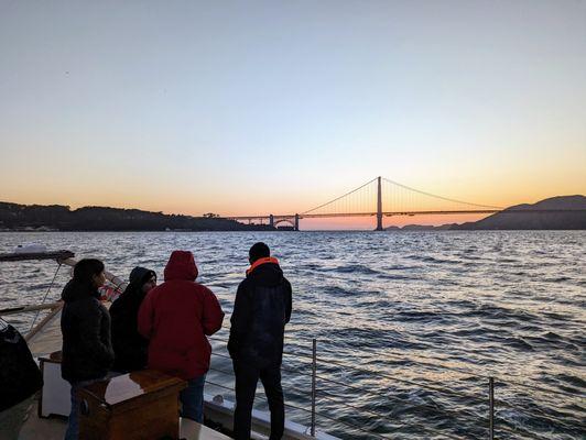 Guests Relax While Viewing the Sunset on the Iconic San Francisco Bay with the Golden Gate Bridge in the Background