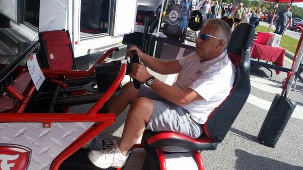 The crowd enjoyed driving the "Firestone Indy Race Car Simulator"!