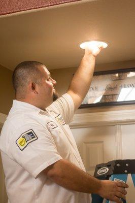 Mike installing a can light in an entry way for his customer.