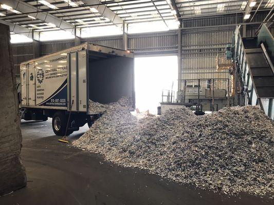 7600 lbs of shredded paper unloaded at the recycling facility