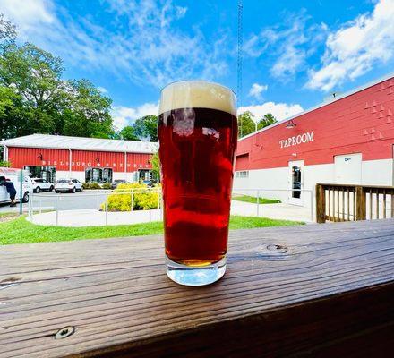 Sitting on the deck that is attached to the Taproom looking over at the Brewhouse where the craft beer & hard seltzer magic happen!