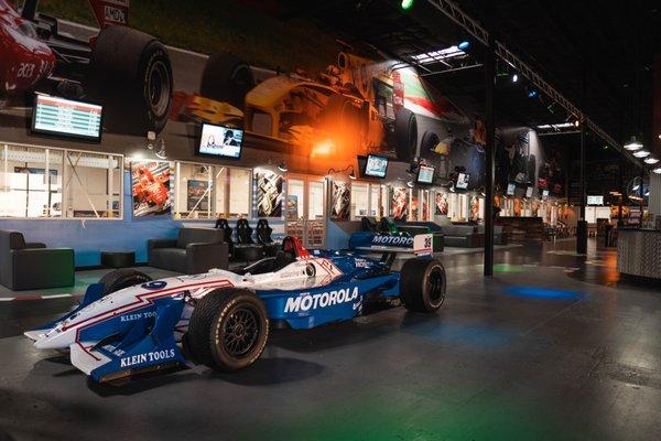 An authentic IndyCar once raced by Michael Andretti sits in the lobby.