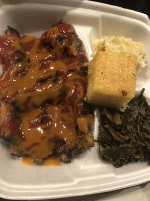 Rib dinner with potatoes salad and collard greens with cornbread