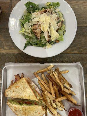 Caesar salad with grilled chicken sandwich and club sandwich