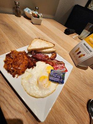 Eggs, Bacon, Toast and Hash Browns $15 (The hash browns are orange colored from all the grease it was cooked in)