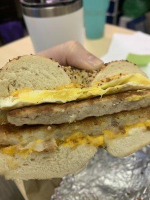 Sausage egg and cheese with a hash brown on an everything bagel