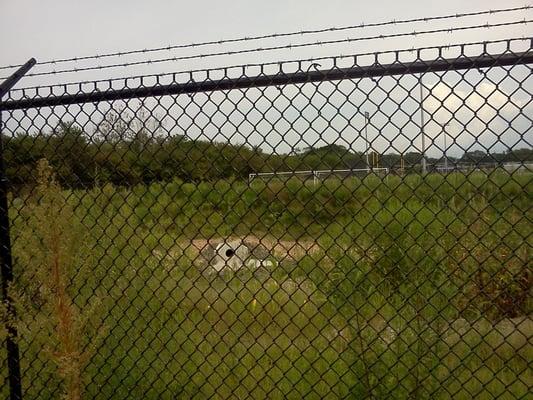 capping contaminated soils and retaining/treating all storm water on site utilizing rain gardens and bio-swales